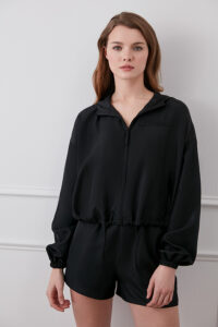 Woman wearing black Athflow women's sun protection hoodie set, front view.