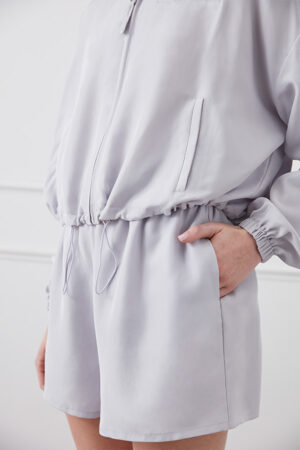 Close-up of pocket and waistband on light gray Athflow women's sun protection hoodie set.