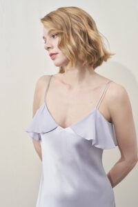 Close-up of MANITO Aurora Silk Nightdress in lavender, highlighting lightweight silk texture and flutter neckline.