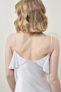 Back view of MANITO Aurora Silk Nightdress in white, featuring delicate spaghetti straps and double ruffle shoulder.
