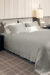 MANITO Authentic Silk Duvet Cover in quartz grey color showcased on a bed with matching pillowcases.