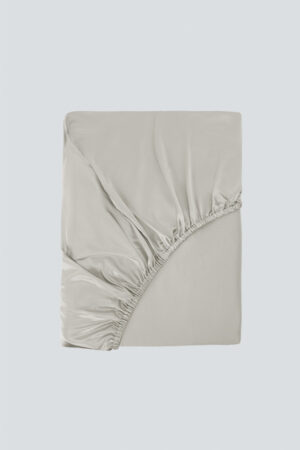 Folded MANITO Authentic Silk Fitted Sheet in gray, showing elastic edge and smooth silk texture.