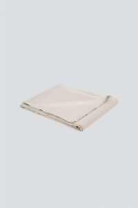 MANITO Authentic Silk Flat Sheet in champagne color, folded to showcase its soft drape.