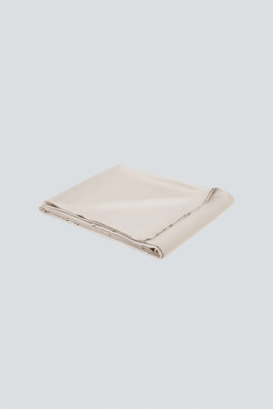 MANITO Authentic Silk Flat Sheet in champagne color, folded to showcase its soft drape.