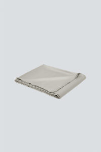 Folded MANITO Authentic Silk Flat Sheet in silver gray, emphasizing premium silk finish.