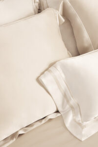 MANITO Authentic Silk Pillowcase Set in cream and ivory, layered to show soft sheen and luxurious texture.
