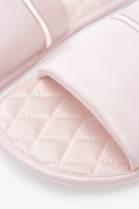 Close-up of blush pink MANITO Authentic Women's Silk Slippers highlighting diamond pattern insole.