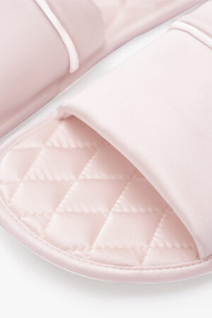 Close-up of blush pink MANITO Authentic Women's Silk Slippers highlighting diamond pattern insole.