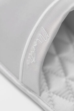 Close-up of gray MANITO Authentic Women's Silk Slippers showing delicate embroidered logo on satin strap.