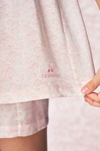 Close-up of BONPOINT×MANITO Ailette Kid's Pajama Set Gift Box logo embroidered on soft pink mulberry silk fabric.