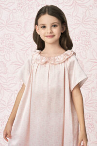 Child modeling BONPOINT×MANITO Celestial Kid's  Nightdress with soft pink silk fabric and elegant ruffle collar.
