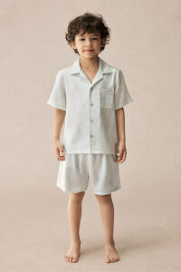 BONPOINT×MANITO Clive Kid's Pajama Set Gift Box shown on a child, featuring short-sleeve silk top and shorts in soft botanical print.