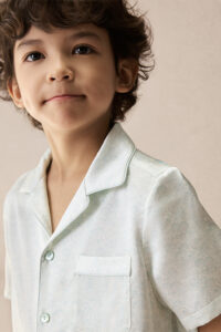 Close-up of BONPOINT×MANITO Clive Kid's Pajama Set Gift Box, highlighting the collar, pocket detail, and smooth silk finish.