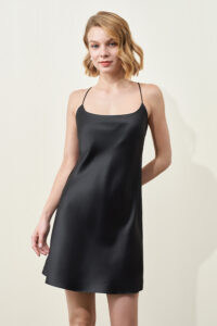 A woman wearing a MANITO basal round-neck silk nightdress stands against a light background.