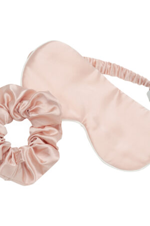 Close-up of Bestie Gift Box pink silk eye mask paired with matching scrunchy.