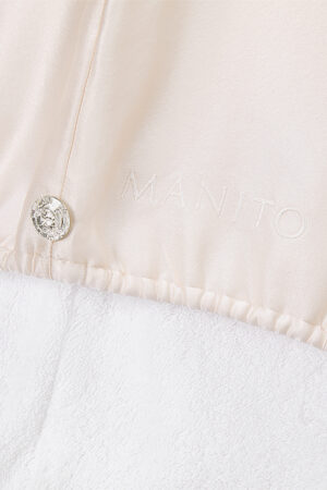 Blooming Silk Hair Turban close-up featuring the crystal-like button and subtle MANITO logo embroidery.