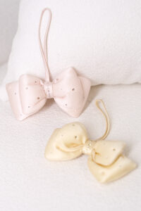 Two Calla Silk Scented Sachets adorned with diamond embellishments, elegantly displayed against a soft white background.