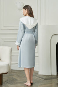 Back view of Calla Women's Hooded Bathrobe in baby blue, highlighting the elegant draped hood and flowing silk finish.