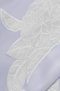 Detailed view of camellia embroidery on MANITO Camellia Silk Long Robe showing fine stitching and texture.