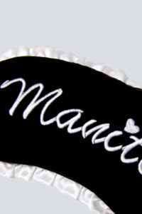 MANITO Charlotte Luxury Silk Eye Mask for Sleeping with Manito embroidery detail.