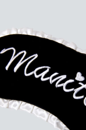 MANITO Charlotte Luxury Silk Eye Mask for Sleeping with Manito embroidery detail.