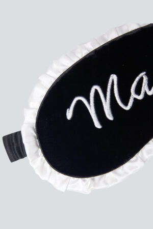 Front view of MANITO Charlotte Luxury Silk Eye Mask for Sleeping with white ruffle trim.