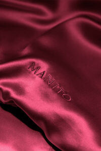 MANITO Classic Soft Light Bedding Set in wine red, illustrating the minimalist design and elegant drape of the silk fabric.