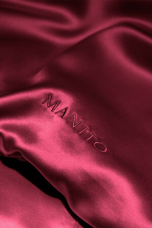 MANITO Classic Soft Light Bedding Set in wine red, illustrating the minimalist design and elegant drape of the silk fabric.