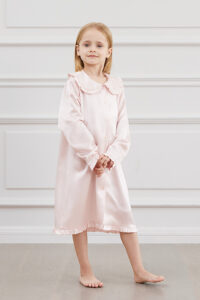 A girl wearing a pink Cloud Silk Nightgown with a classic collar and button details.