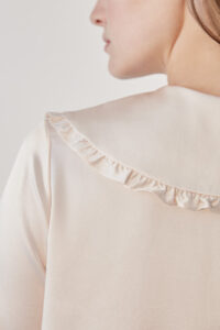 Close-up of the back of MANITO Cloud cute pink pajama set, highlighting the ruffled collar.