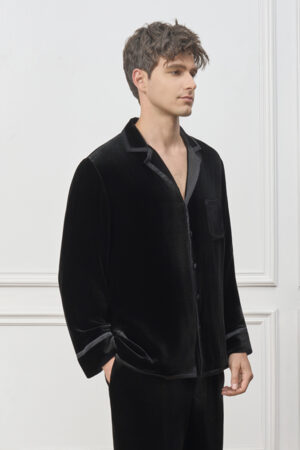 Side view of man in Combo Velvet Pajama Set, black velvet shirt and pants draping softly for quiet evening lounging.