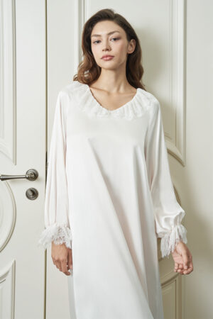 Front view of woman wearing white Court Women's Nightdress, highlighting the lace V-neck and cuffs in soft silk.