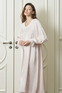 Woman wears pink Court Women's Nightdress in a relaxed pose, with airy puff sleeves and a flowing A-line silhouette for serene grace.