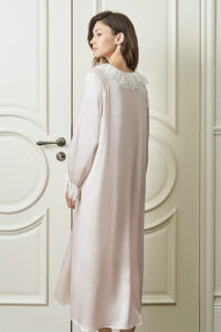 Woman wears pink Court Women's Nightdress back view, as the lace-trimmed neckline and soft drape evoke timeless charm.