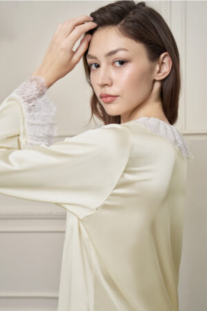 Side view of model in Court Women's Pajama Set, showcasing the flowing silk and delicate lace details.