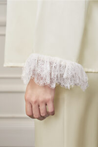Close-up of Court Women's Pajama Set cuff with airy lace trim, adding romantic charm to the smooth silk fabric.