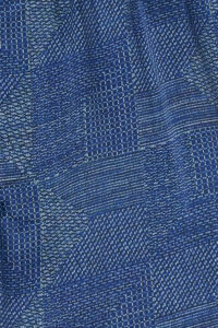 Fabric detail of Cube Men's Shorts, highlighting smooth silk with delicate geometric dot and line patterns.