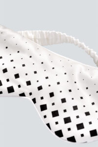 Close-up of the front of MANITO Cubes Silk Eye Mask, showing the spiral diamond grid pattern.