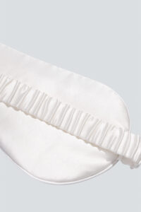 Close-up of the back of MANITO Cubes Silk Eye Mask, showing the plain white back and its secure strap.