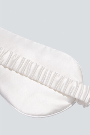 Close-up of the back of MANITO Cubes Silk Eye Mask, showing the plain white back and its secure strap.