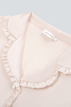 A close-up reveals the intricate ruffled collar of Daisy Women's Pink Pajama Set, adorned with the brand's label.