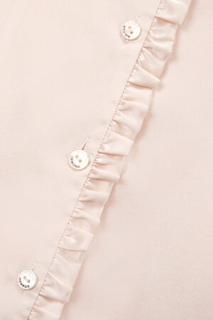 An even closer look at the buttons on Daisy Women's Pink Pajama Top showcases the brand's logo and the fine ruffled detailing.