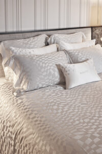Damier Silk Duvet Cover with abstract chessboard pattern, paired with matching pillows.