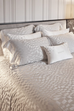 Damier Silk Duvet Cover with abstract chessboard pattern, paired with matching pillows.