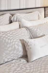 Damier Silk Duvet Cover with matching pillows featuring abstract chessboard design.
