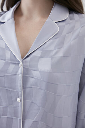 Close-up of MANITO Damier Women's Pajama Set fabric with geometric silk jacquard and button detail.