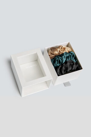 3 Pack Large Silk Scrunchie Set in gold, emerald, and black, merging rich tones and smooth texture for timeless sophistication.