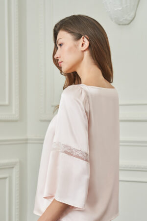 Side view of woman in MANITO Dream Women's Pajama Set, highlighting the soft sheen and delicate lace band on sleeves.