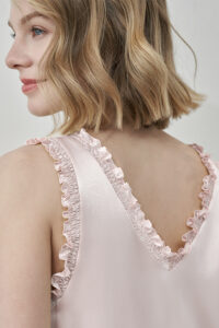 Back detail of MANITO Duchess Silk Ruffle Dress in pink showing soft ruffle-lined V back.