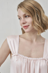 Close-up of MANITO Duchess Tank Silk Maxi Dress showing pleated shoulder strap and bow detail.